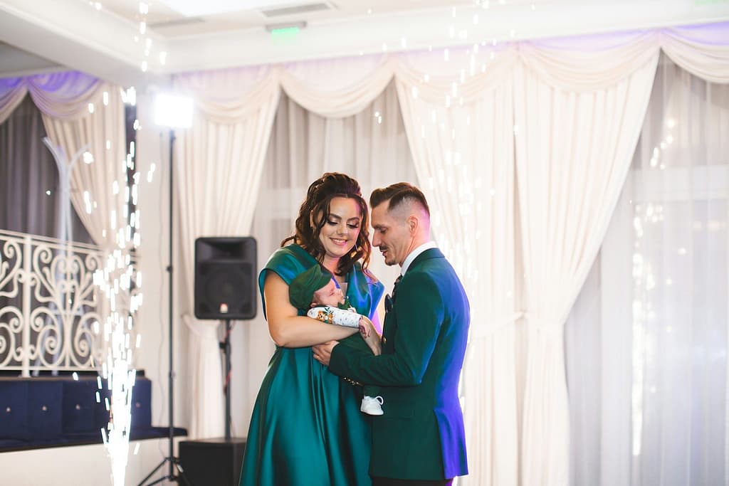 Couple embracing with sparklers at a formal event