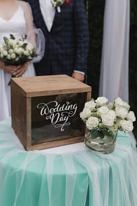 A Memory Box Beside a Bouquet of White Flowers