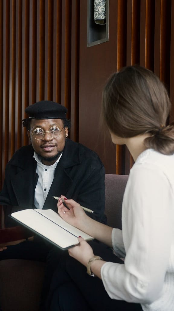 Man talking to someone taking notes