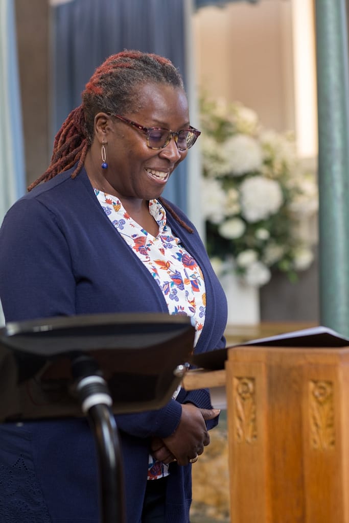 a woman standing in front of a wooden podium