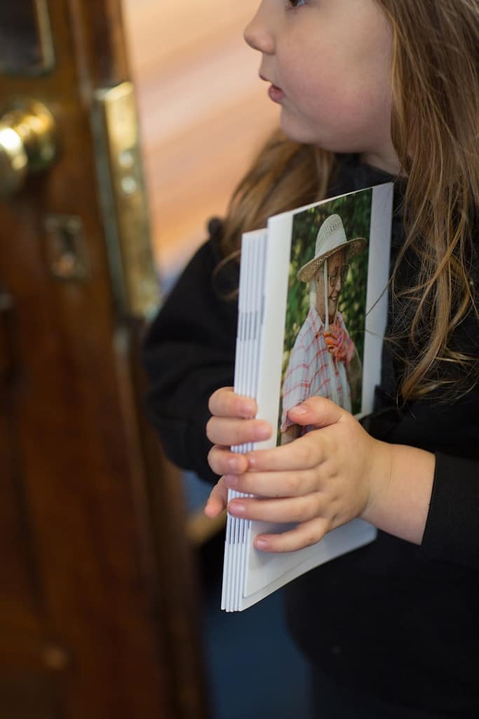a young girl holding a photo of her loved one